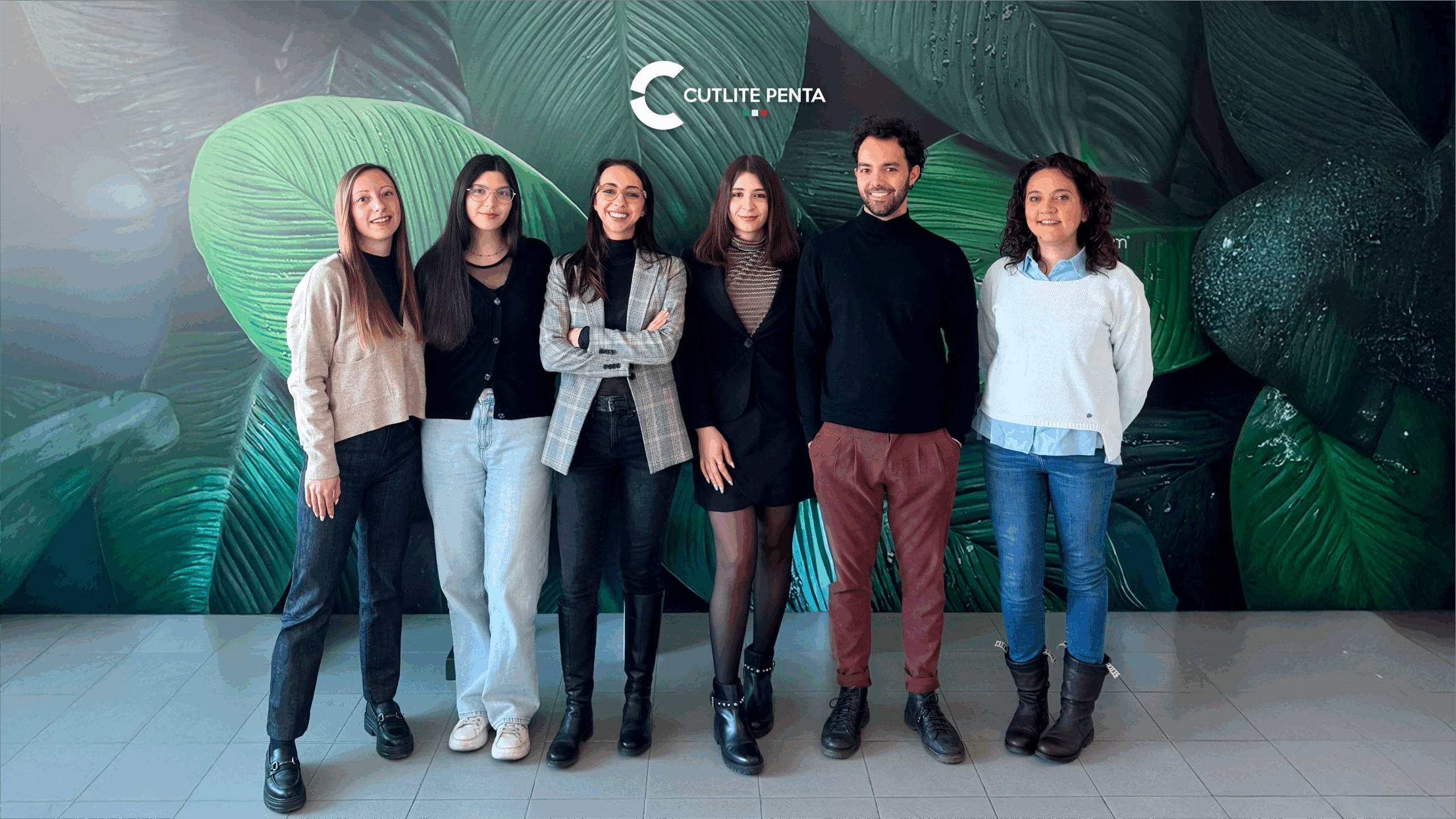 Il team del commerciale estero di Cutlite Penta in posa davanti alla parete decorata degli uffici: Chiara Tedesco Maida, Gabriel Iacopini, Emanuela Nacci, Marta Tuliani, Viola Falchi e Giulia Barbetti