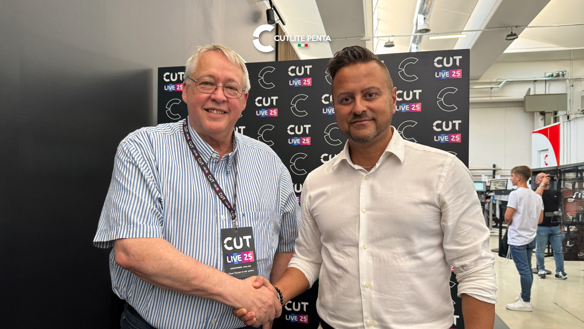 Jeff Cupples of Cupples J&J Company Inc. and Andrea Falaschi of Cutlite Penta shaking hands in front of the CUTLIVE backdrop in the Prato demo area