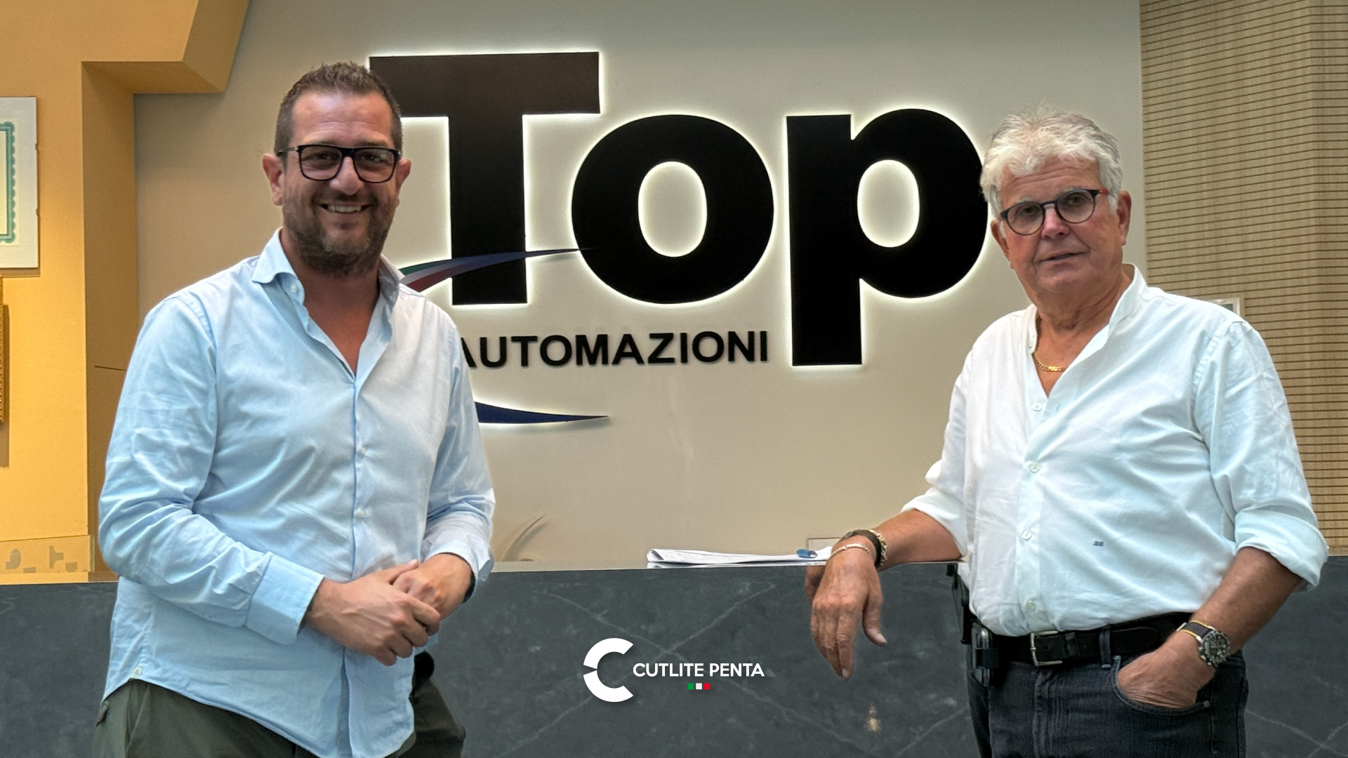 Bruno Bargellini di Top Automazioni con Andrea Giolli di Cutlite Penta davanti al logo aziendale