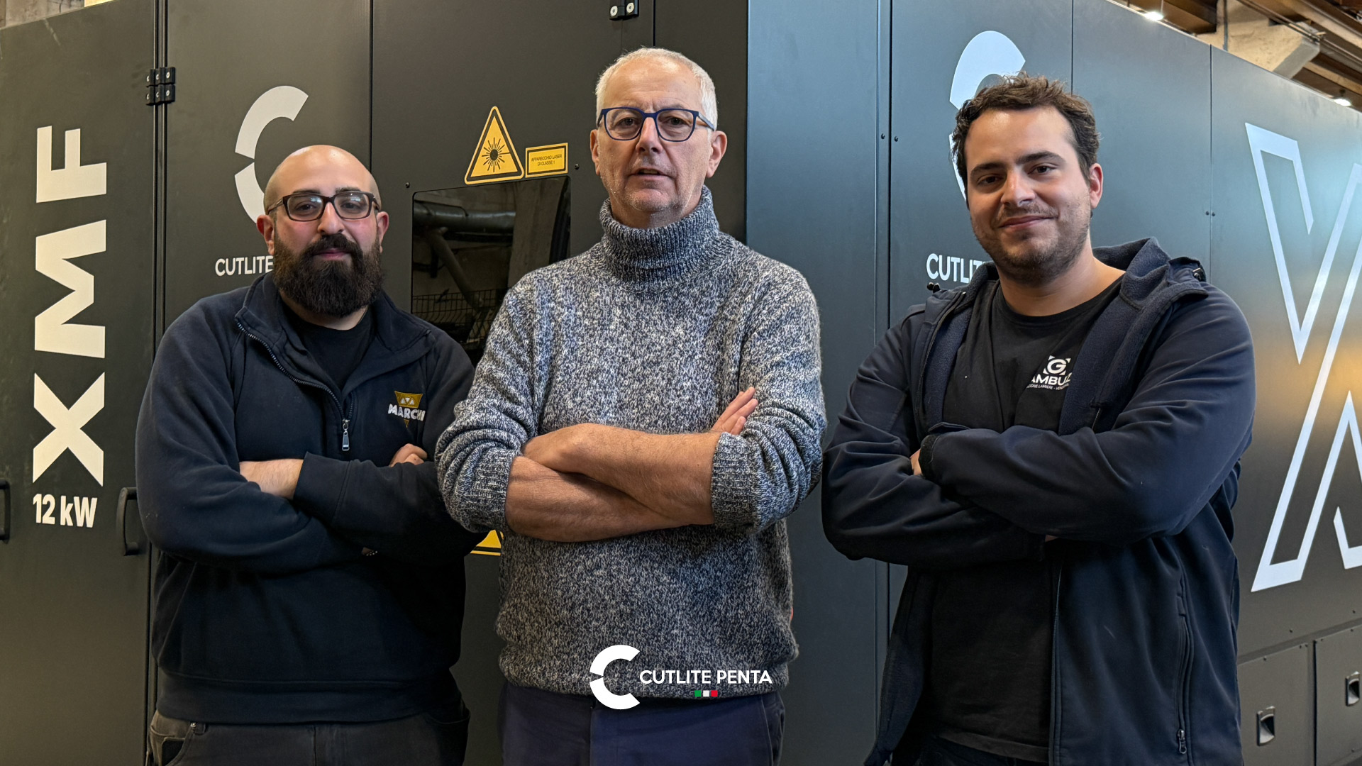 Il Signor Gambuzzi con il figlio e un tecnico davanti alla XMF 12 kW nera in officina