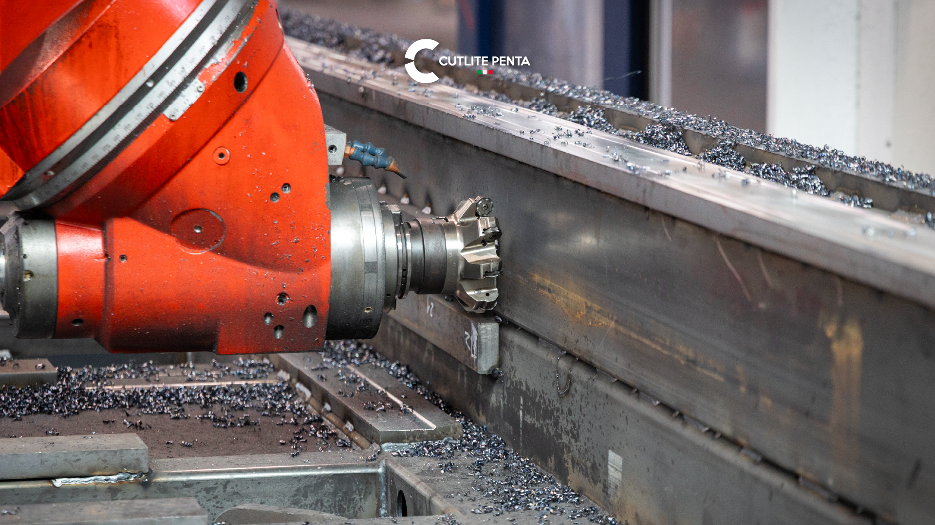 Close-up of the milling cutter machining the side of the frame bed, among steel chips