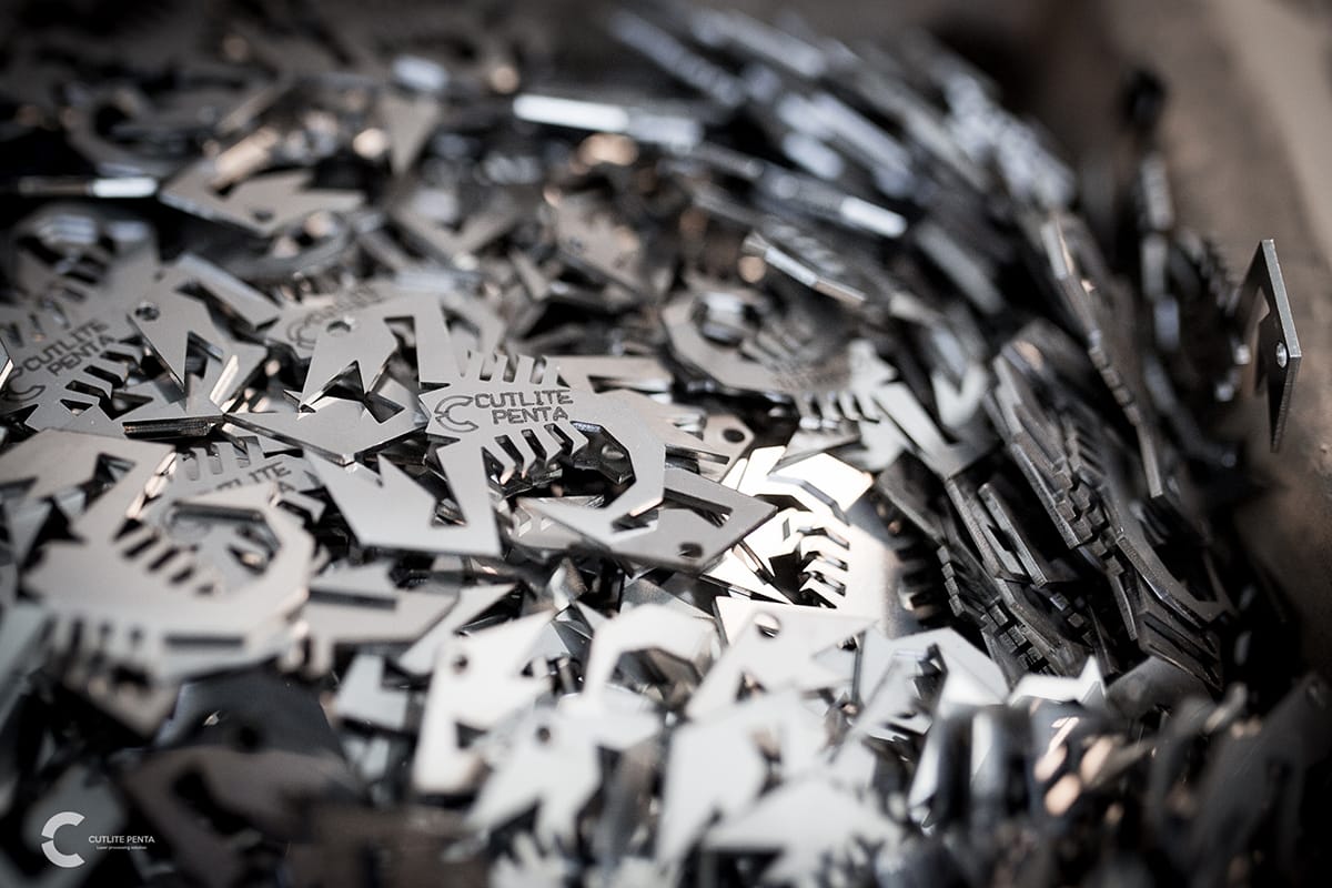 Metal components cut with fiber laser and the Cutlite Penta logo