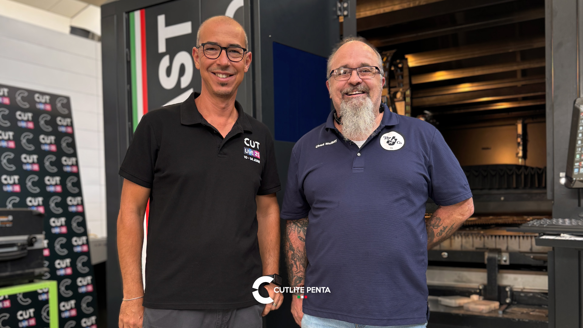 Chad Mulkey of Cupples J&J with a Cutlite Penta technician in front of a laser machine at the Prato site